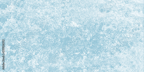 Soft light blue cement wall texture featuring a rough weathered surface with white speckled distressing ideal for a subtle grunge background