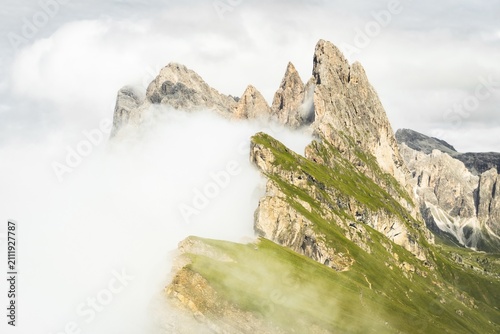 Dramatic Seceda mountain peaks scenic view Dolomites Alps Italy summer daytime green alpine meadow clouds travel destination photography background