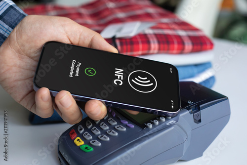 Man hand phone Contactless NFC Mobile Payment POS Terminal Screen