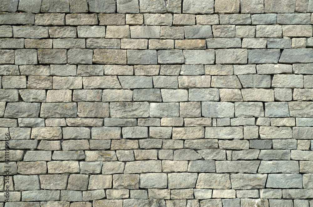Fototapeta premium Gray chiseled stone block wall masonry texture background