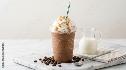 Refreshing chocolate frappe with whipped cream and sweet caramel sauce topping in clear plastic cup on marble stone board with coffee beans and milk jug ideal for cafe menu or summer drink promotions.