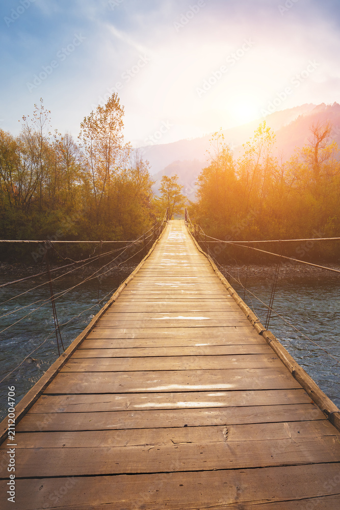 Fototapeta premium Hanging rope wooden bridge over mountain river