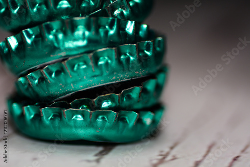 Close‑up of stacked turquoise bottle caps, symbolizing recycling, design and everyday art t