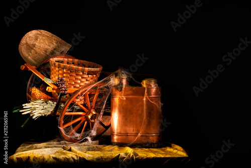 Harvest wheelbarrow with copper flask and spiderweb