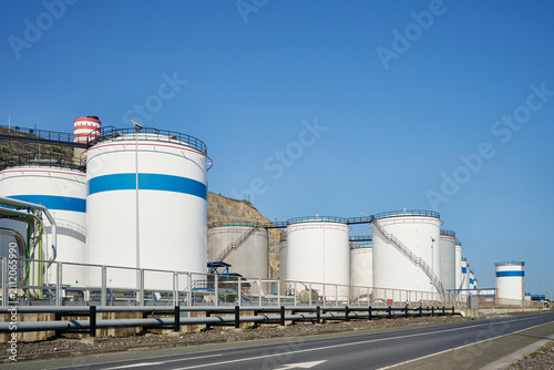 Industrial storage tanks holding liquid chemicals and fuel