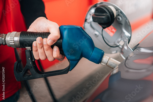 Cuadro en lienzo a close-up view of a person refueling a vehicle