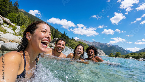 A group of diverse and joyful young friends laughing together while swimming in a clear mountain river during a summer vacation, capturing a wide angle selfie in nature.