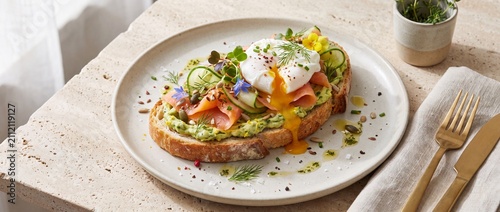Avocado toast with poached egg and salmon. Gourmet breakfast dish with smoked fish.