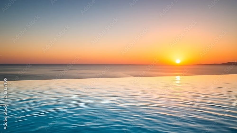 Obraz premium A serene infinity pool with gentle ripples, overlooking the ocean at sunset.