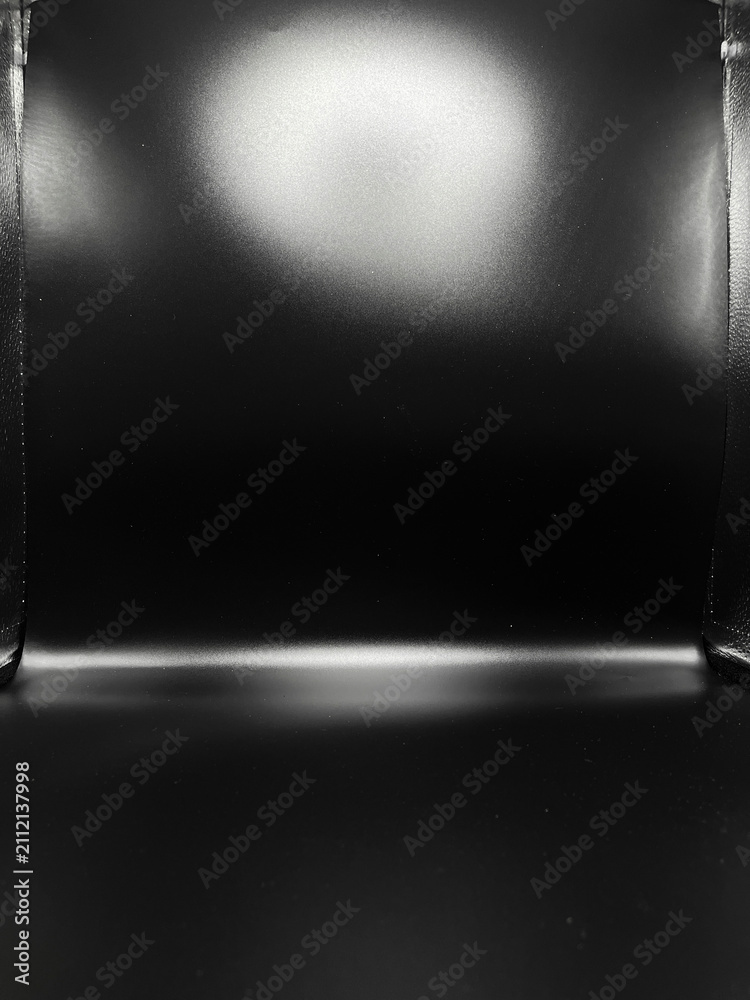 Obraz premium Empty black studio lightbox backdrop with top gradient lighting