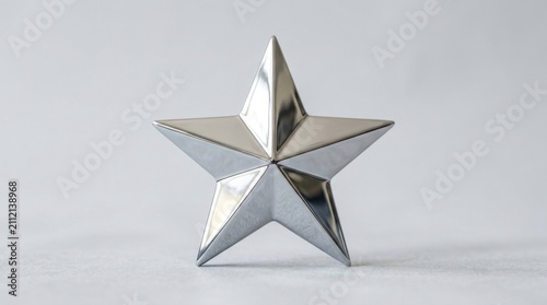 A shiny silver star with a reflective surface, standing upright on a plain white background.