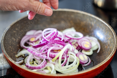 Photography Stockholm, Sweden White sliced onions frying in a pan.