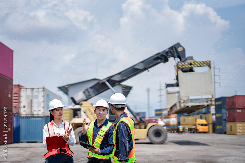 Fototapeta premium Container terminal workers coordinate lifting operation using tablet, clipboard and radio communication. Cargo inspection, logistics planning, shipping operations, warehouse management.