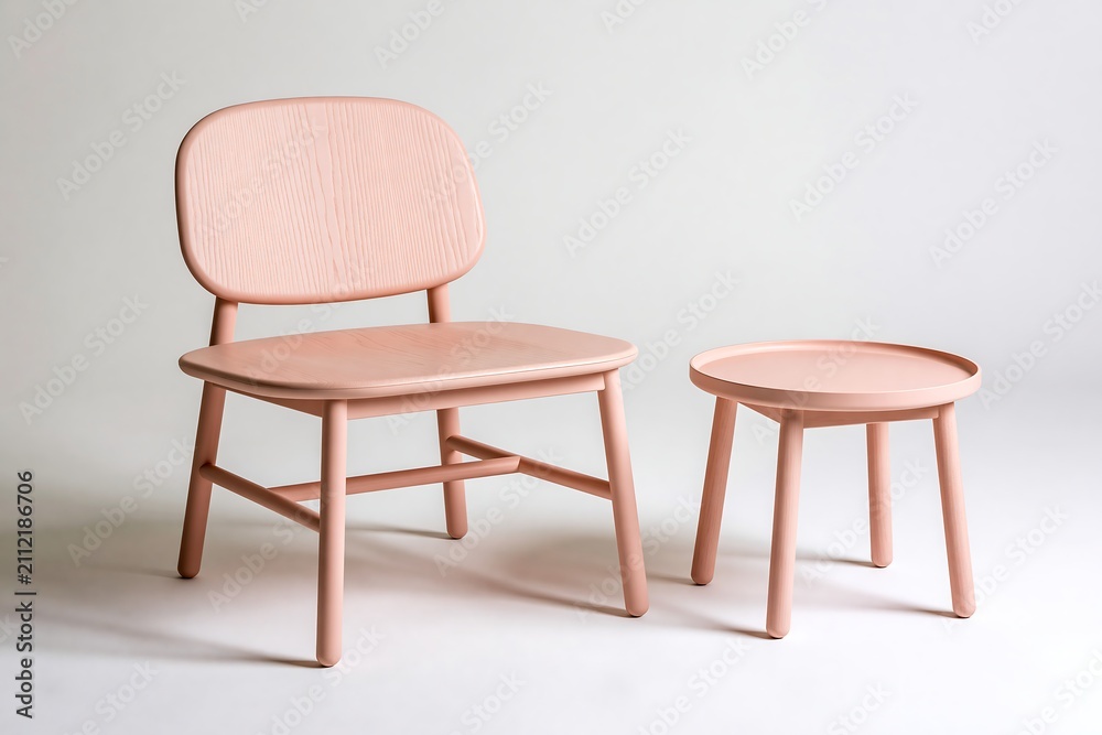 Fototapeta premium A modern pink wooden chair and a small round side table isolated on a white background