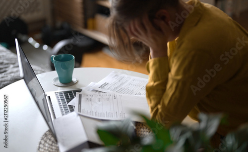 фотографія Stressed woman having financial problems with paying bills.