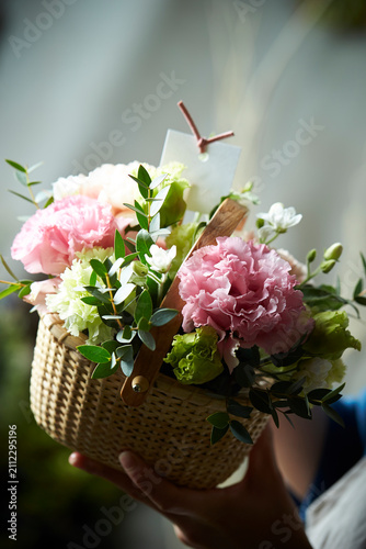 Flower basket in the florist's hands