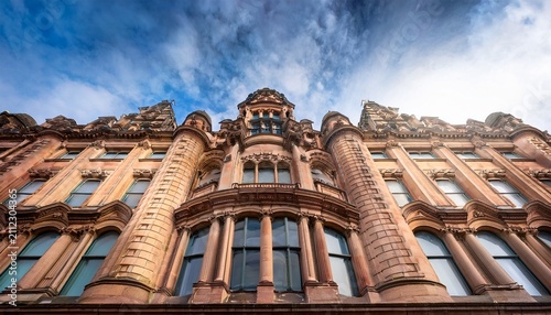 historic victorian sandstone building with ornate bay windows and carved facade in liverpool uk viewed from a dramatic upward perspective