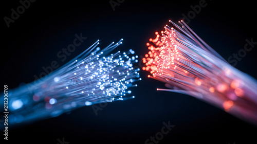 Close-up view of fiber optic cables glowing in dark navy background with blue and red strands