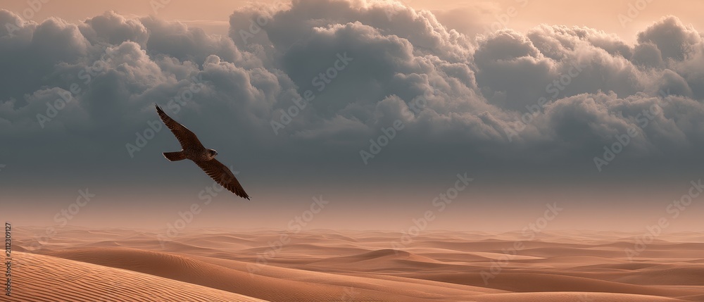 Fototapeta premium Majestic Bird Flying Over Dramatic Desert Landscape at Dusk
