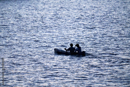 2 people on a small boat