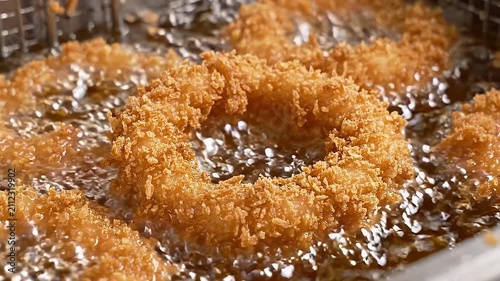Golden Crispy Onion Rings Deep Frying in Hot Bubbling Oil for a Delicious Appetizer