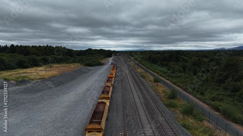 Aerial View of a Yellow Freight Train on Railway Tracks in Ireland