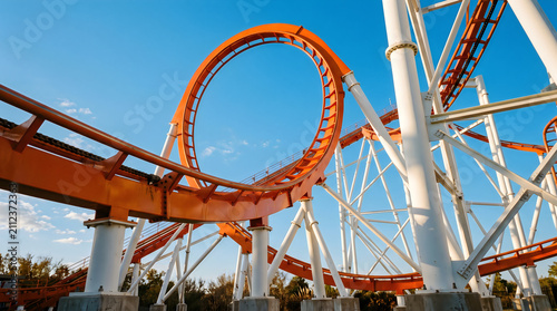 Obraz na płótnie Orange Roller Coaster Vertical Loop Against Clear Blue Sky