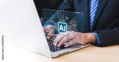 Business professional using modern laptop with artificial intelligence futuristic interface.