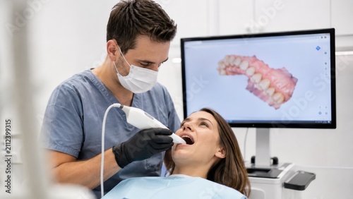 Dentist using intraoral scanner wand for 3D digital dental scan