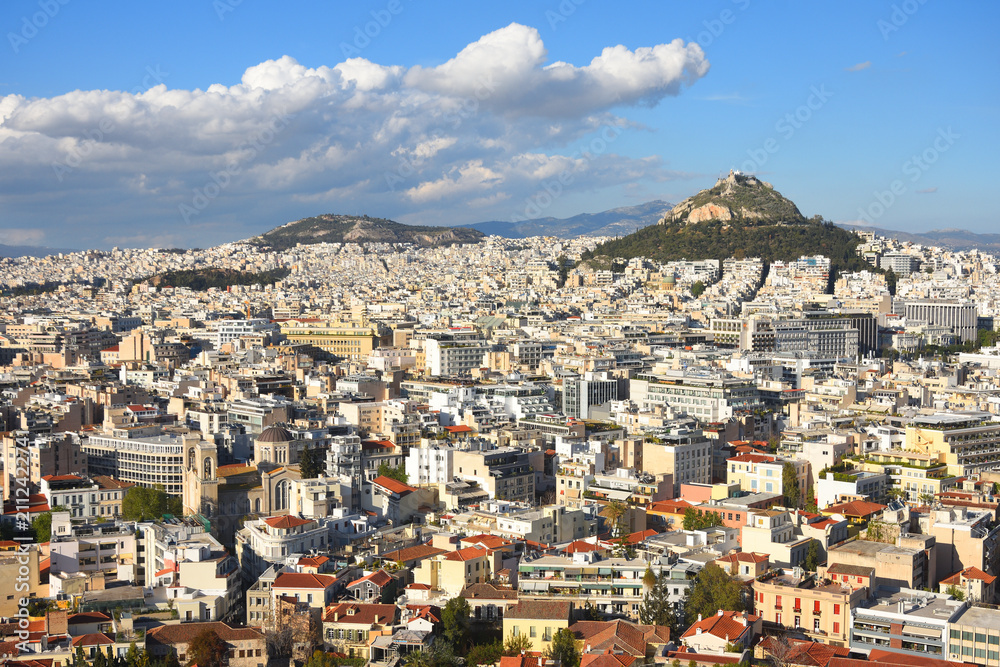 Fototapeta premium View to Athens cityscape and the Lykavitos hill with a big cloud in the sky. Greece. 
