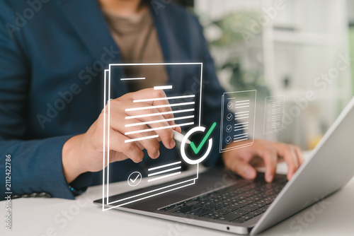 Businessman approving digital invoice on tablet and laptop, paperless billing system, e invoice management, and efficient online finance workflow.