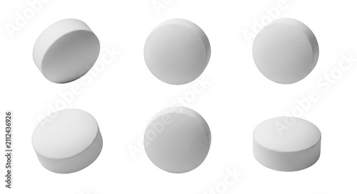 isolated white pills arranged on white creating a simple health care and medication theme ready for use in pharmaceutical medical projects