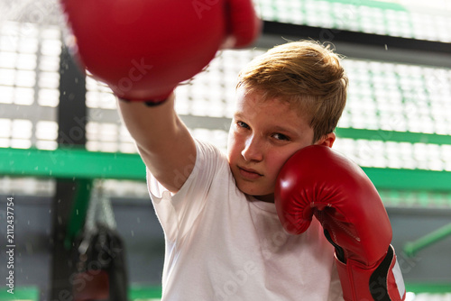 Fotografie Young boxer practicing powerful punches.