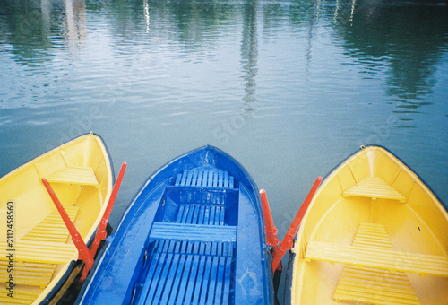 Colorful Boats Docked Near Calm Water in a Marina During Midday
