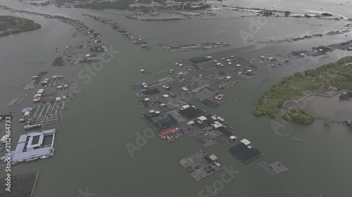 Aerial drone footage of oyster farming in Long Son, Ho Chi Minh City, Vietnam, showcasing traditional aquaculture, floating oyster farms, coastal fishing industry and sustainable seafood production.