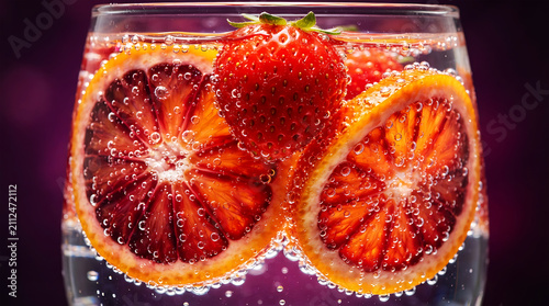 Fresh orange slices and strawberries in glass bowl fruit
