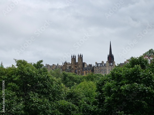 Old buildings behind trees on a cloudy day in Edinburgh, Scotland