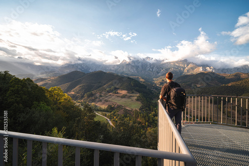 man walking on a bridge
