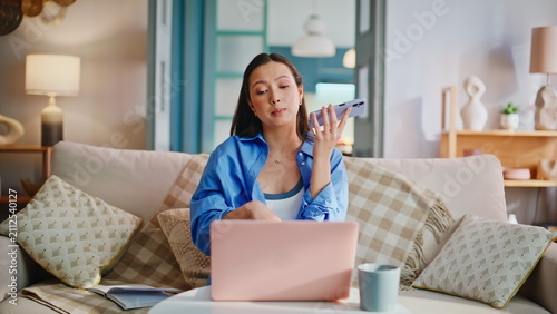 Bild auf Leinwand Woman speaking speakerphone sofa home