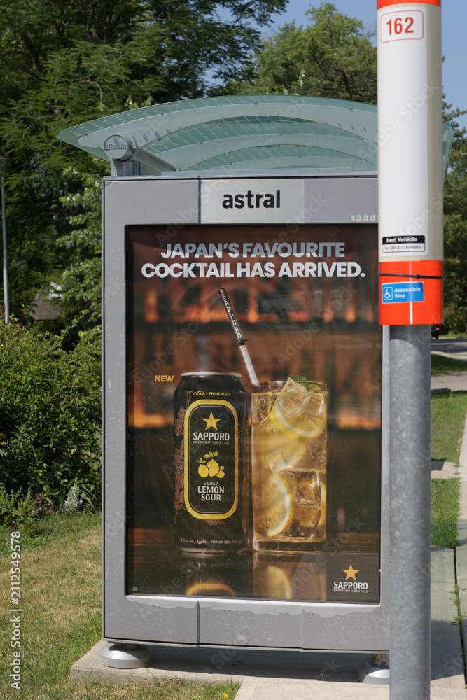 Obraz premium bus shelter with OOH advertising poster for Sapporo Vodka Lemon Sour with bus stop of TTC #162 Lawrence-Donway, Toronto