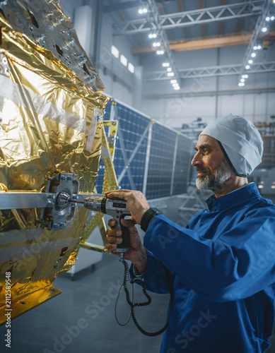 Aerospace Technician Assembling Satellite in Clean Room