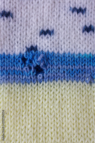Fotografie Hole in knitted fabric close up for clothing repair concept