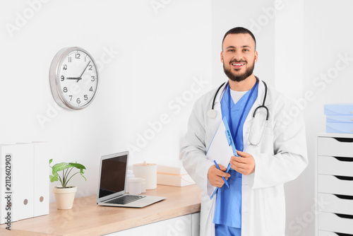 Smiling male doctor in a wh...