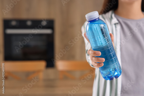 Person holding a blue plast...