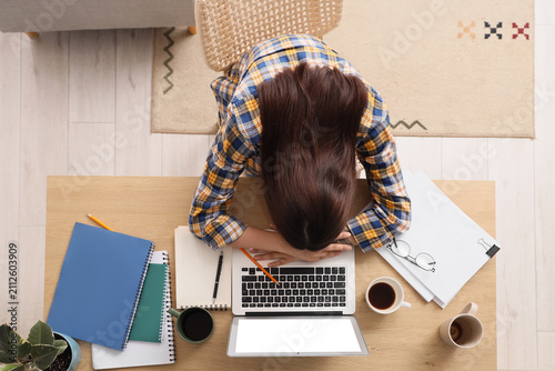 Overworked young woman slee...