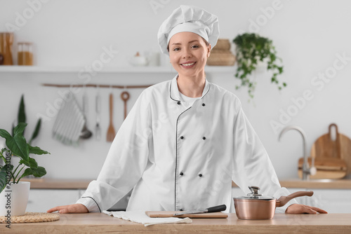 Smiling female chef in a wh...
