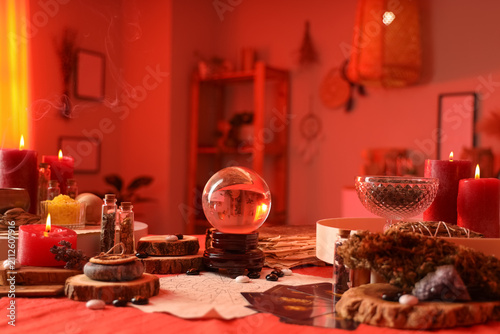 Fotografía Fortune tellers magic attributes with burning candles on table in room