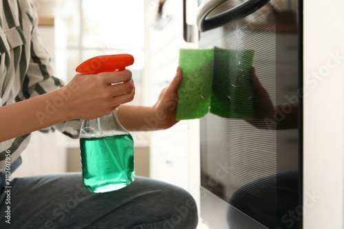 Woman with sponge cleaning ...