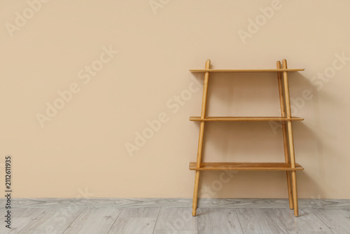 Empty wooden bookshelf near...