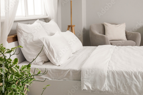 Big bed with white linen in...